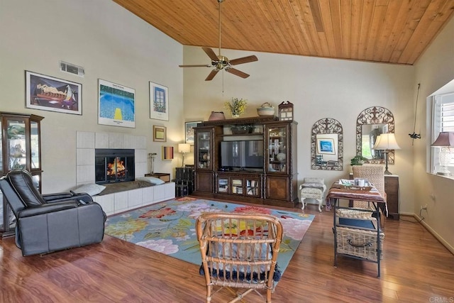 29839 Circle R Creek Ln, Escondido, CA 92026 - living room featuring wooden ceiling, a ceiling fan, wood finished floors, a tiled fireplace, and high vaulted ceiling