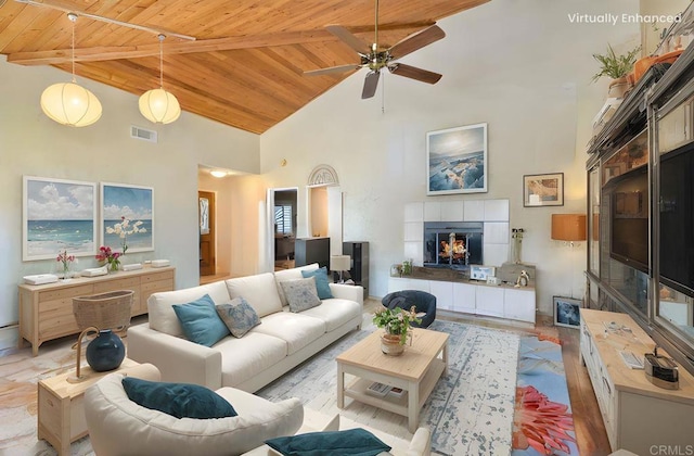 29839 Circle R Creek Ln, Escondido, CA 92026 - living room featuring wooden ceiling with exposed beams, high vaulted ceiling, a tile fireplace, and a ceiling fan