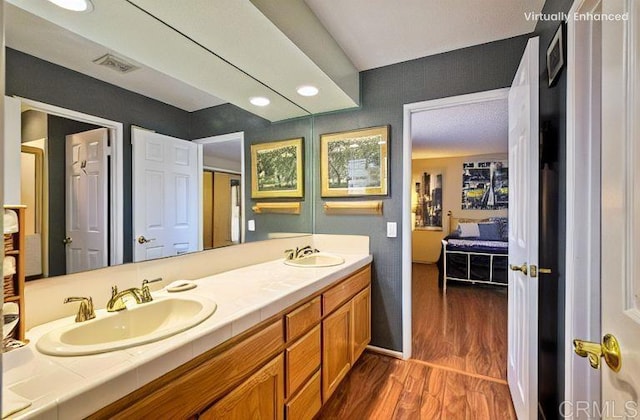 29839 Circle R Creek Ln, Escondido, CA 92026 - ensuite bathroom with double vanity, wood finished floors, and recessed lighting