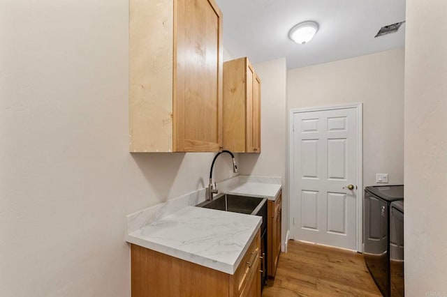 20191 Deerben Rd, Ramona, CA 92065 - washroom with washer and clothes dryer, light wood-type flooring, and cabinet space