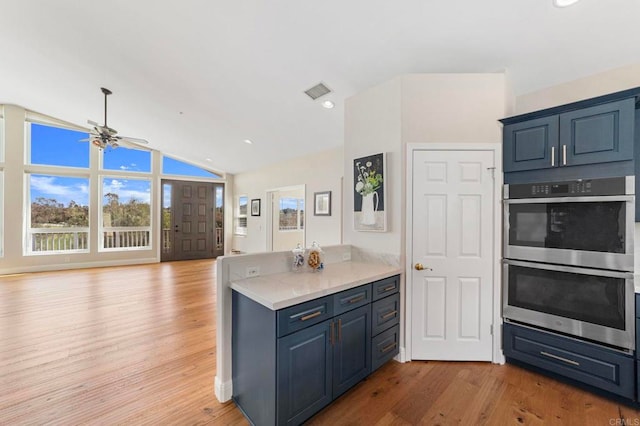20191 Deerben Rd, Ramona, CA 92065 - kitchen featuring stainless steel double oven, ceiling fan, light wood-style floors, lofted ceiling, and open floor plan