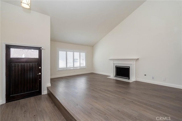 24461 Peacock St, Lake Forest, CA 92630 - entryway with lofted ceiling, wood finished floors, a fireplace with flush hearth, and baseboards