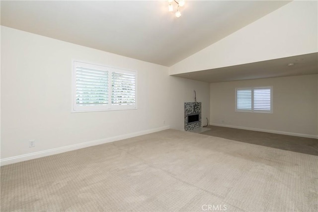 24461 Peacock St, Lake Forest, CA 92630 - unfurnished living room featuring carpet, a fireplace with flush hearth, baseboards, and lofted ceiling
