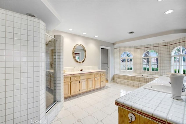 bathroom featuring vanity, recessed lighting, a shower stall, visible vents, and a bath