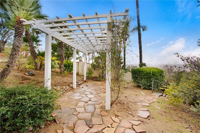 view of patio with a pergola and fence