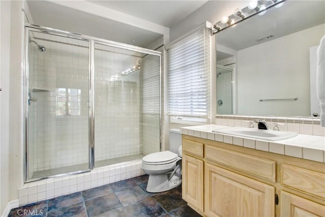 bathroom featuring a shower stall, vanity, visible vents, and toilet