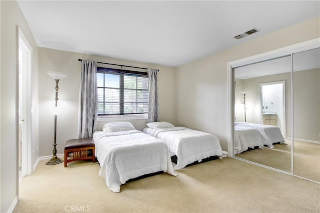 bedroom featuring light carpet, baseboards, and visible vents
