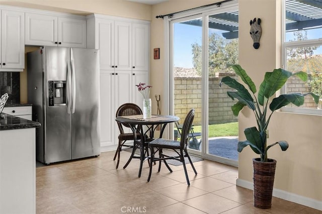 14209 Wrangell Ln, Canyon Country, CA 91387 - dining space with plenty of natural light, light tile patterned floors, and baseboards
