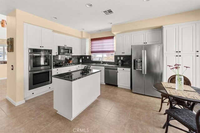 14209 Wrangell Ln, Canyon Country, CA 91387 - kitchen with stainless steel appliances, plenty of natural light, backsplash, a center island, and recessed lighting