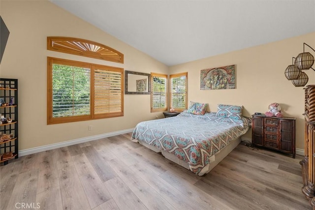 14209 Wrangell Ln, Canyon Country, CA 91387 - bedroom featuring multiple windows, wood finished floors, vaulted ceiling, and baseboards