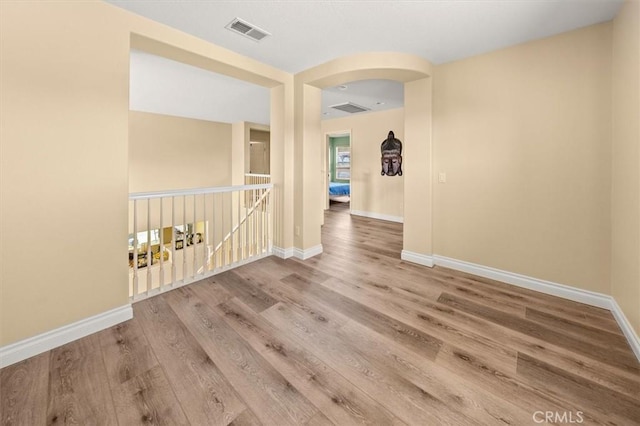 14209 Wrangell Ln, Canyon Country, CA 91387 - spare room with baseboards, wood finished floors, and arched walkways