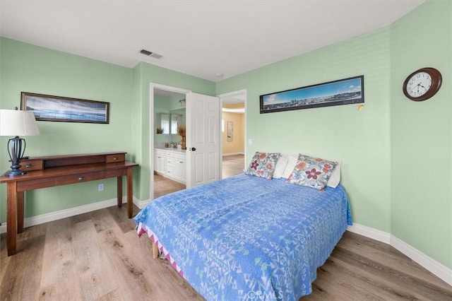 14209 Wrangell Ln, Canyon Country, CA 91387 - bedroom with wood finished floors, baseboards, and connected bathroom