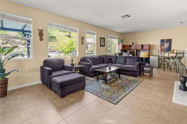 14209 Wrangell Ln, Canyon Country, CA 91387 - living room with plenty of natural light, light tile patterned floors, and baseboards