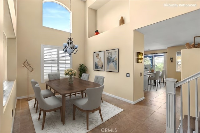 14209 Wrangell Ln, Canyon Country, CA 91387 - tiled dining area with a chandelier, a towering ceiling, and baseboards