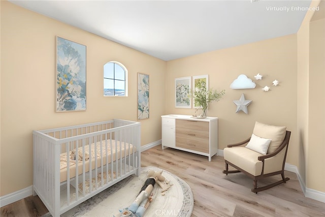 14209 Wrangell Ln, Canyon Country, CA 91387 - bedroom with light wood-type flooring, baseboards, and a nursery area