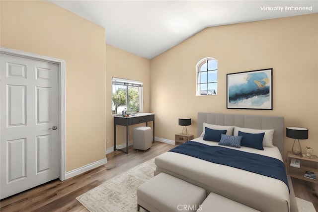 14209 Wrangell Ln, Canyon Country, CA 91387 - bedroom with lofted ceiling, wood finished floors, and baseboards