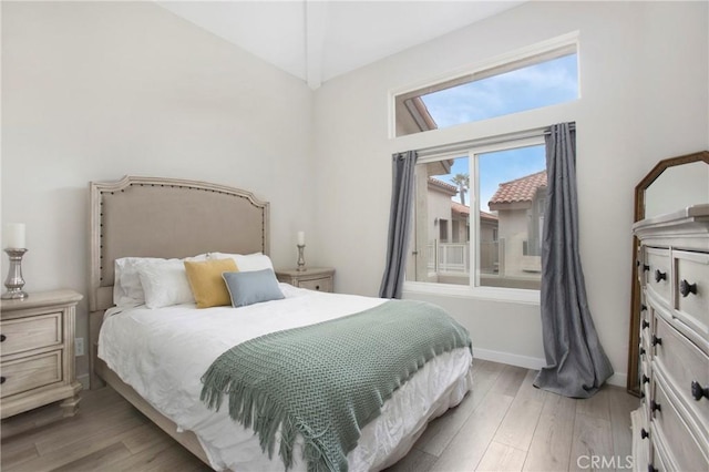 1400 Pacific Coast Unit 305, Huntington Beach, CA 92648 - bedroom featuring high vaulted ceiling and light wood-style flooring