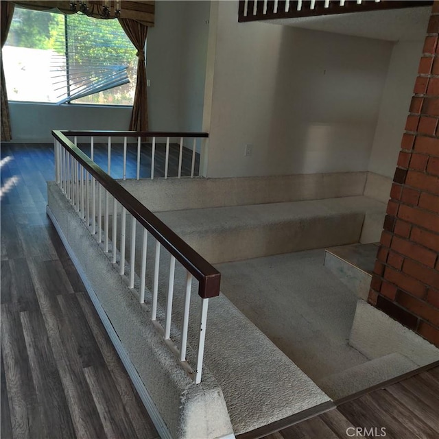 stairway with a chandelier and wood finished floors