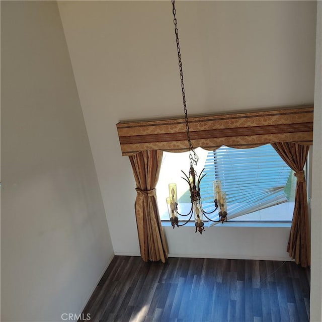 interior details with a chandelier and wood finished floors