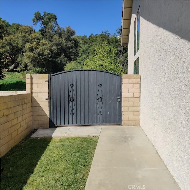 view of gate featuring fence