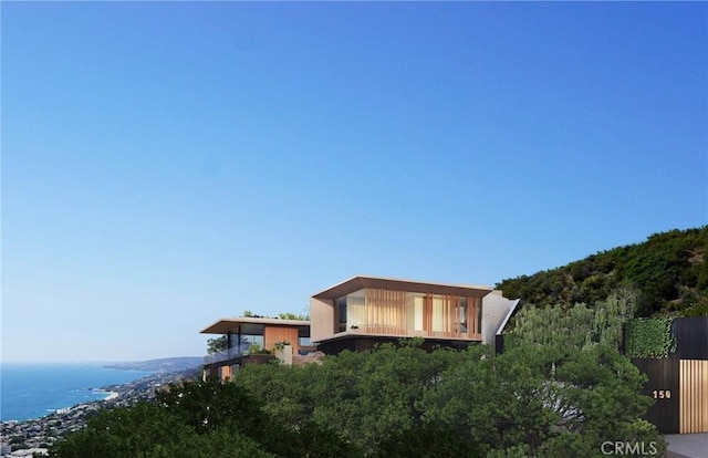 exterior space with a water view and fence