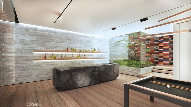 interior space with a dry bar and wood finished floors