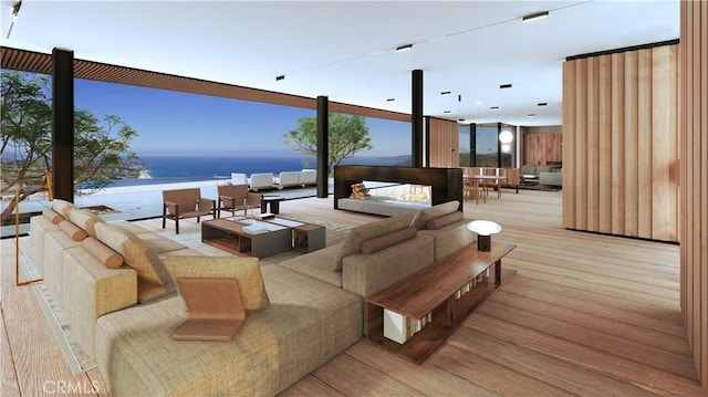 deck with an outdoor living space and a water view