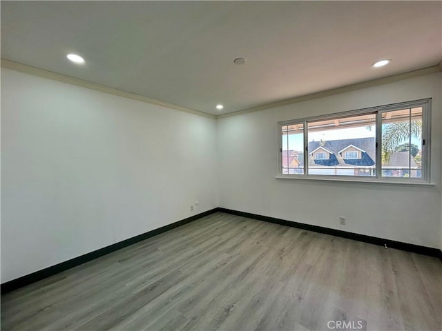 unfurnished room featuring recessed lighting, crown molding, and wood finished floors