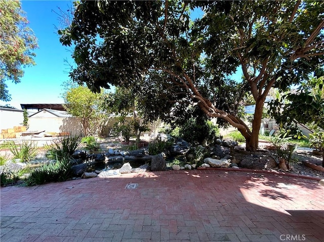 view of yard with fence and a patio