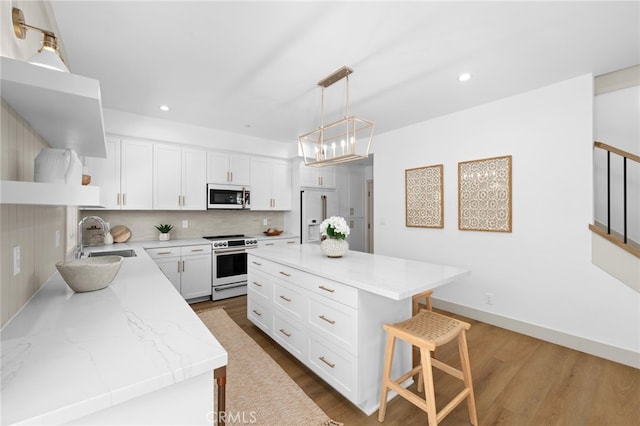 kitchen with electric range oven, a sink, high quality fridge, white microwave, and backsplash