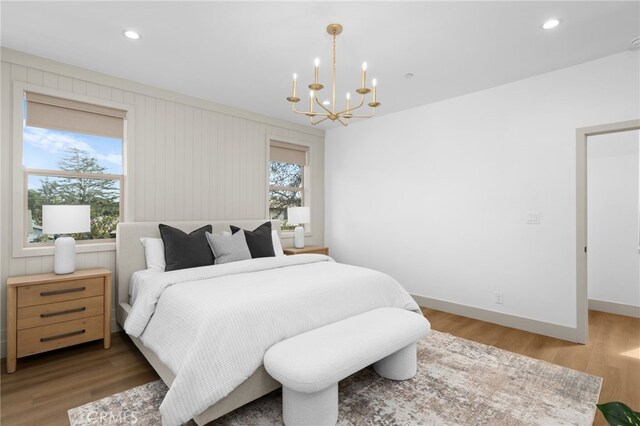 bedroom featuring a chandelier, recessed lighting, light wood-style flooring, and baseboards