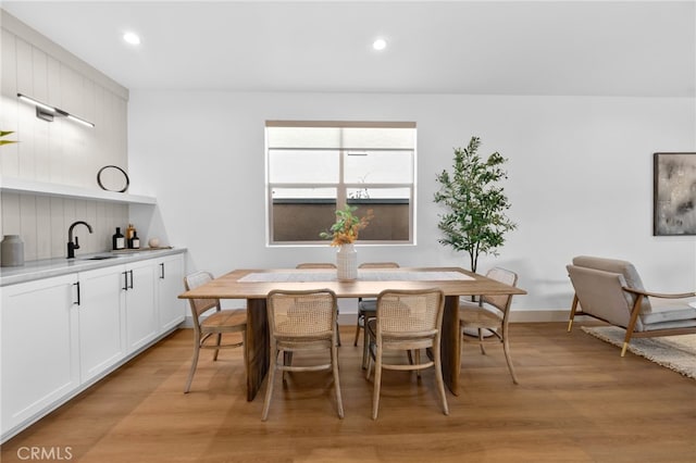 dining area with light wood-style floors and recessed lighting