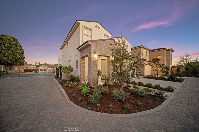 view of side of property with stone siding and stucco siding