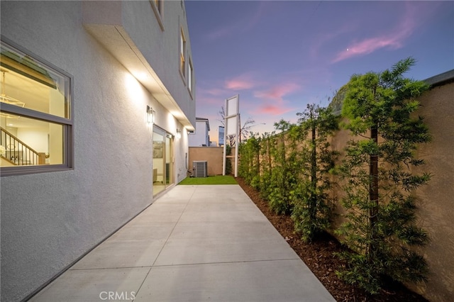 exterior space with central air condition unit and a fenced backyard