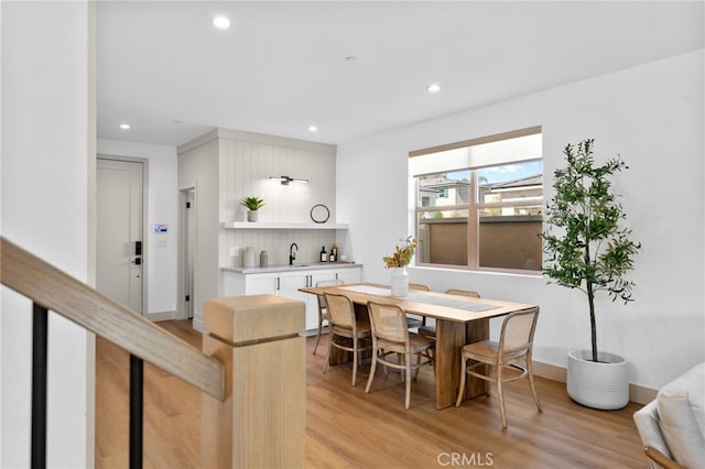 dining area with light wood-style floors, baseboards, and recessed lighting