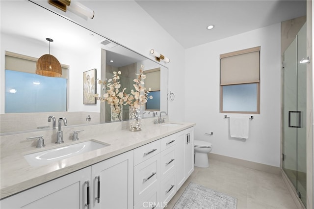 full bathroom with a sink, toilet, double vanity, and a stall shower