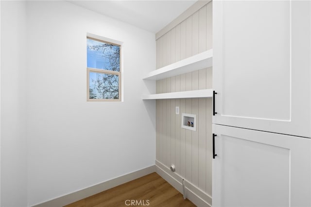washroom featuring light wood-style flooring, hookup for a washing machine, laundry area, and baseboards