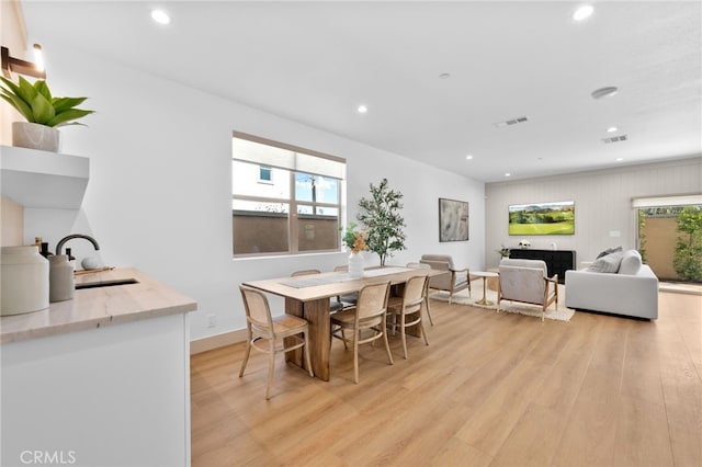 dining space with light wood-style floors, recessed lighting, and visible vents