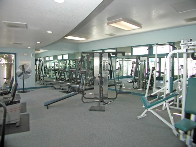 workout area with recessed lighting and a textured ceiling