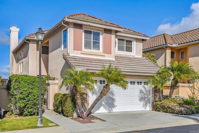 view of front of home featuring a garage, a tile roof, stucco siding, and driveway