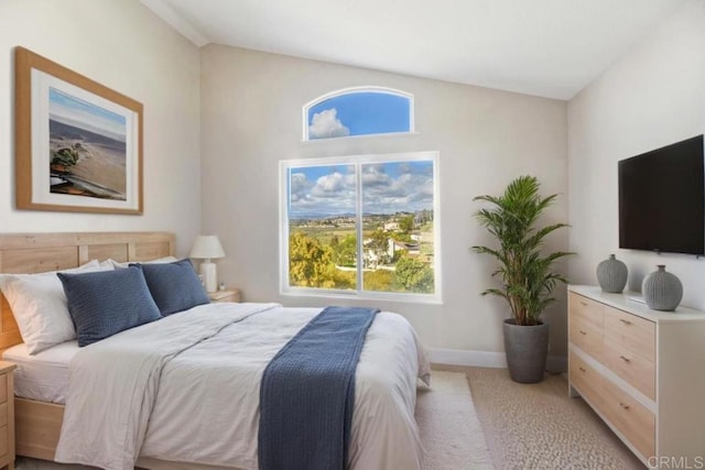 bedroom with baseboards and light colored carpet