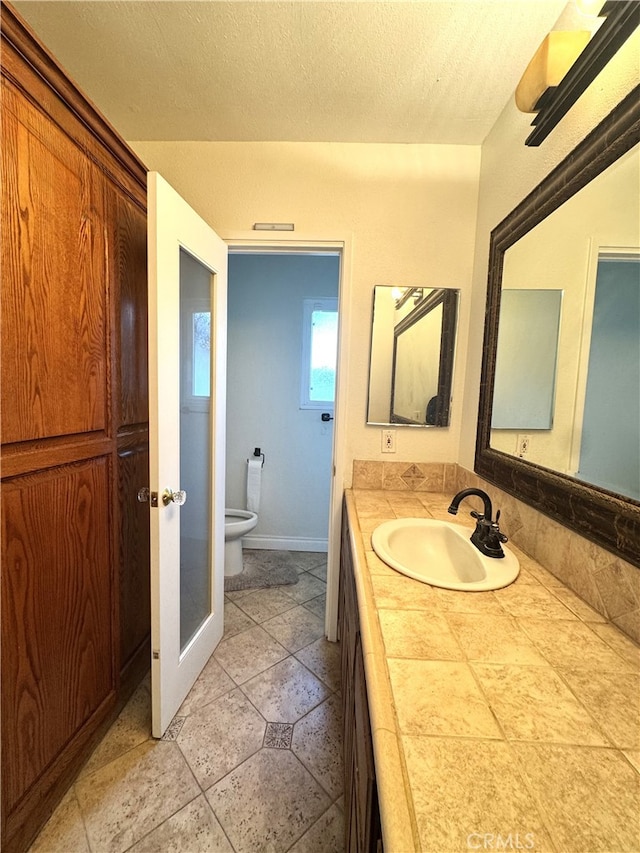 234 Santa Rosa Rd, Arcadia, CA 91007 - bathroom with vanity, a textured ceiling, baseboards, and toilet