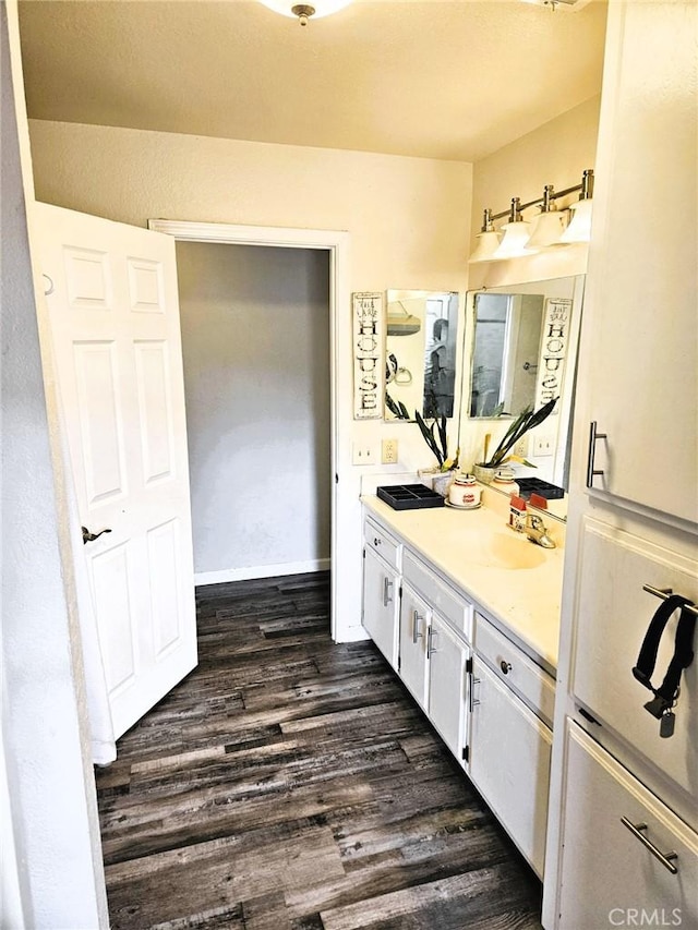 15433 Idaho Ln, Apple Valley, CA 92307 - bathroom with vanity, baseboards, and wood finished floors