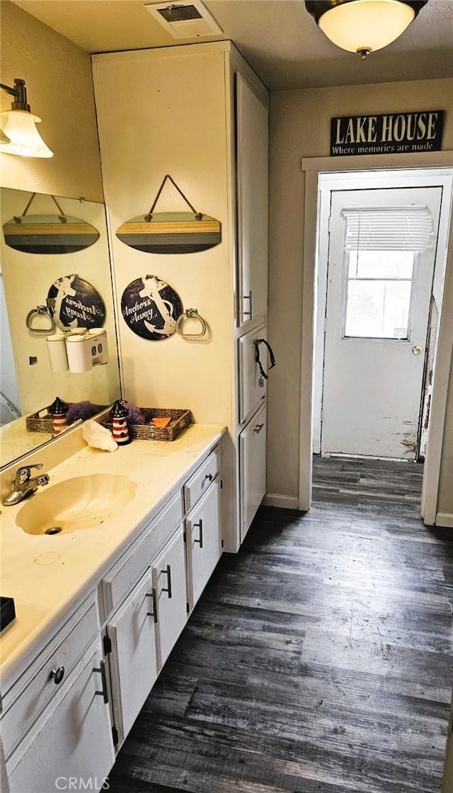 15433 Idaho Ln, Apple Valley, CA 92307 - bathroom with wood finished floors, a sink, and visible vents