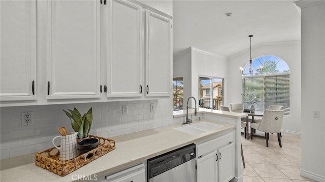 kitchen featuring a notable chandelier, vaulted ceiling, crown molding, dishwasher, and a sink