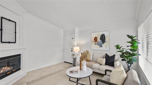 living room featuring a glass covered fireplace, baseboards, crown molding, and light tile patterned flooring