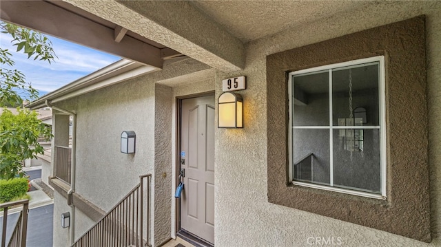 property entrance featuring stucco siding