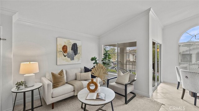 living room featuring plenty of natural light, baseboards, and crown molding