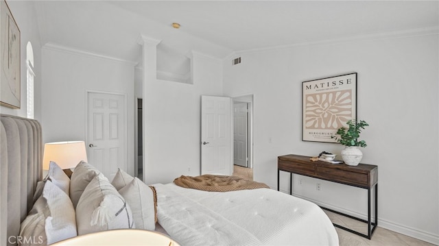 bedroom featuring crown molding, visible vents, vaulted ceiling, and light tile patterned floors