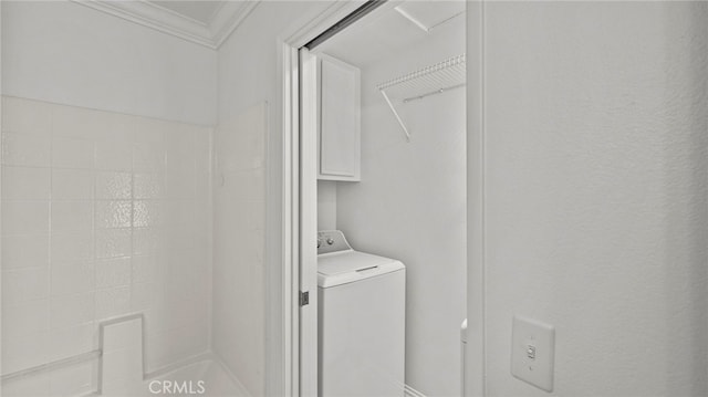 clothes washing area featuring washer / clothes dryer and ornamental molding